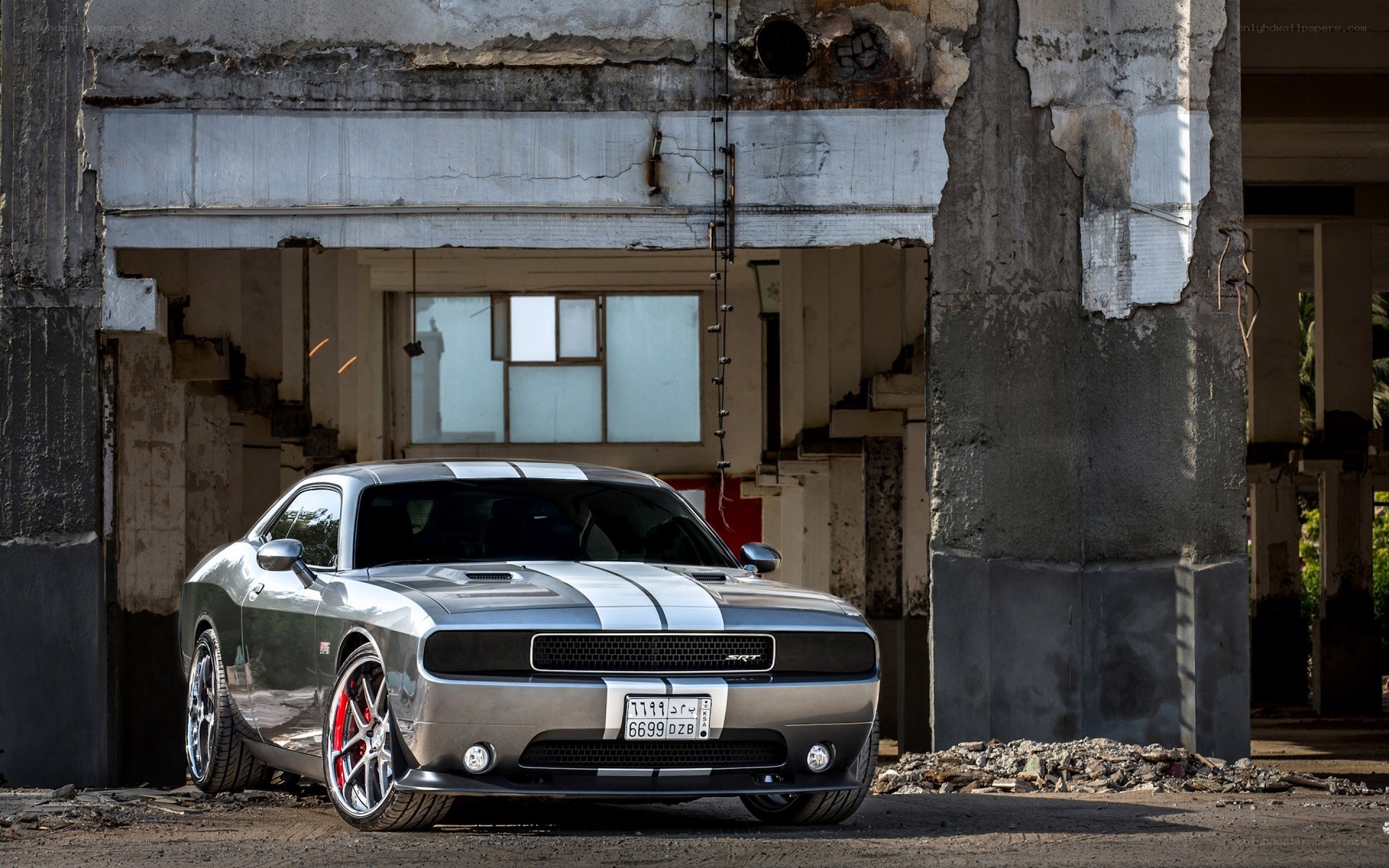 Silver Dodge Challenger in ruins