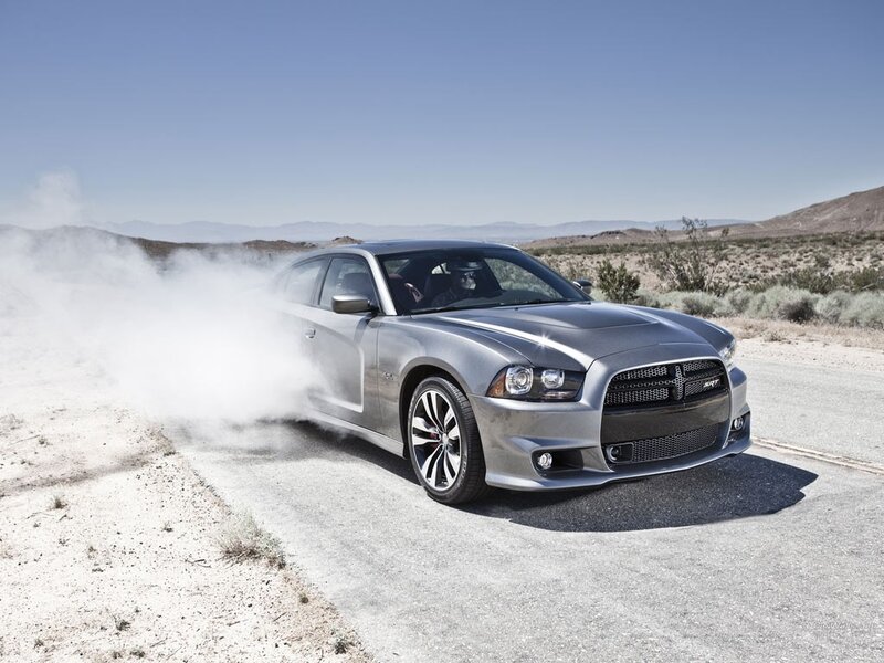 Silver Dodge Charger drifts on desert road