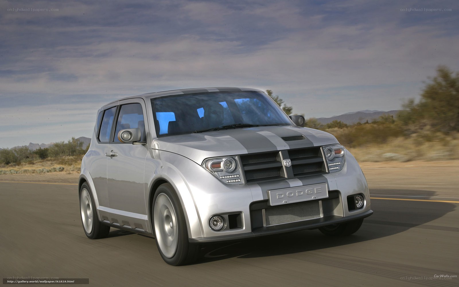 Silver Dodge SUV on desert road