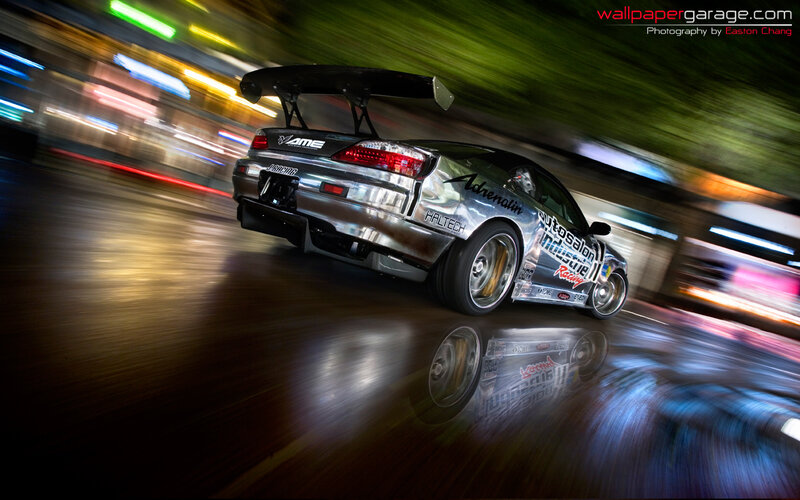 silver drift car at night