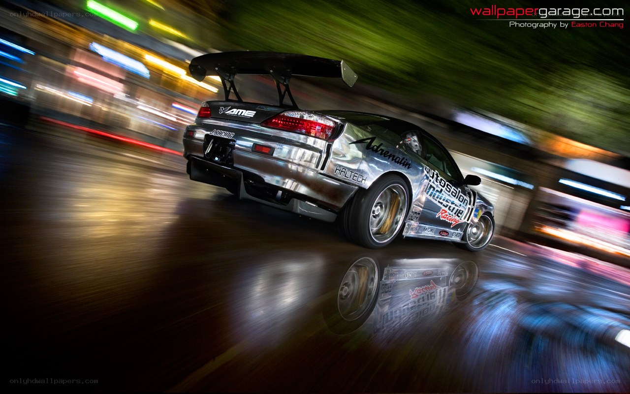 silver drift car at night