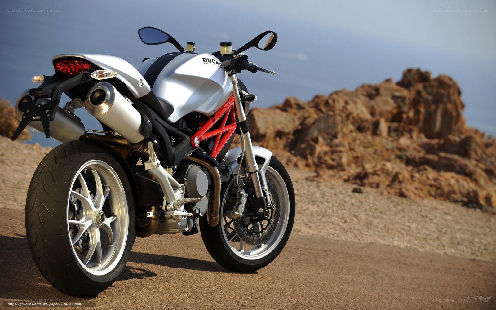Silver Ducati motorcycle on a cliff