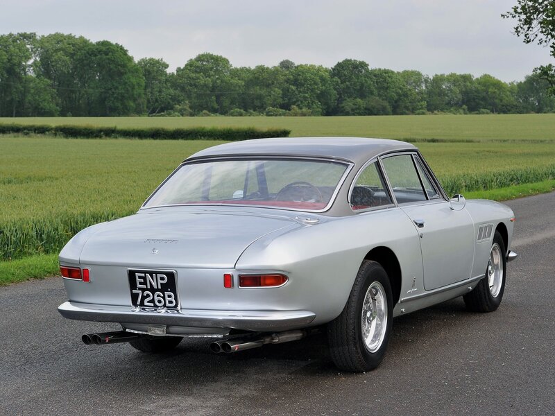 Silver Ferrari 330 GT on a country road