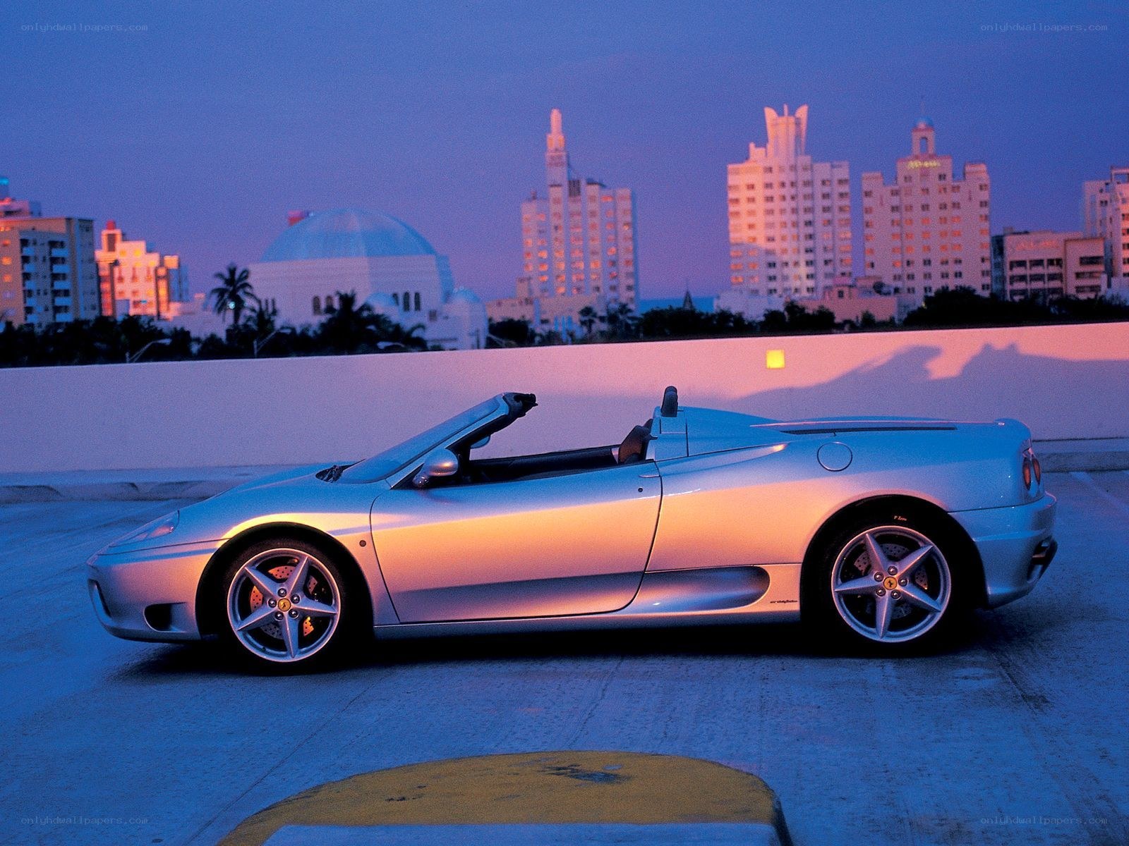 Silver Ferrari convertible at dusk