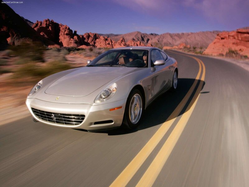 silver ferrari driving on desert road