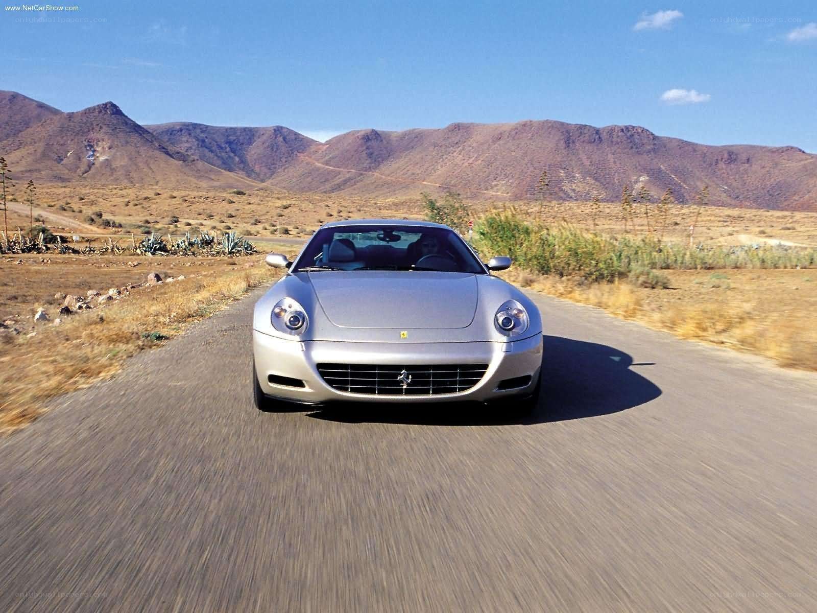 silver ferrari driving on road