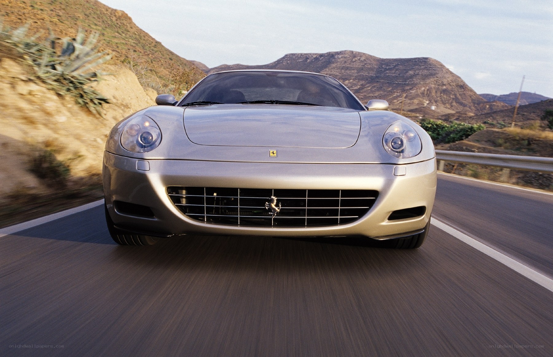 Silver Ferrari driving on road