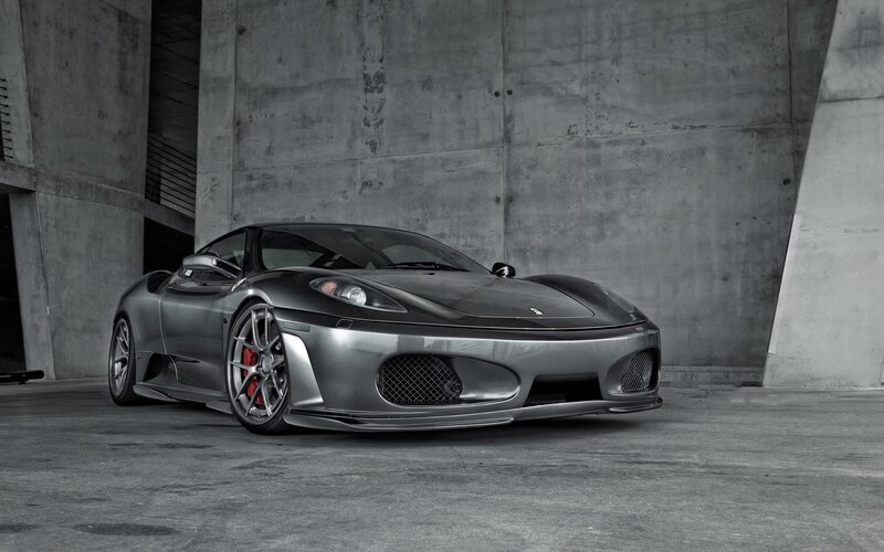 silver ferrari in concrete garage