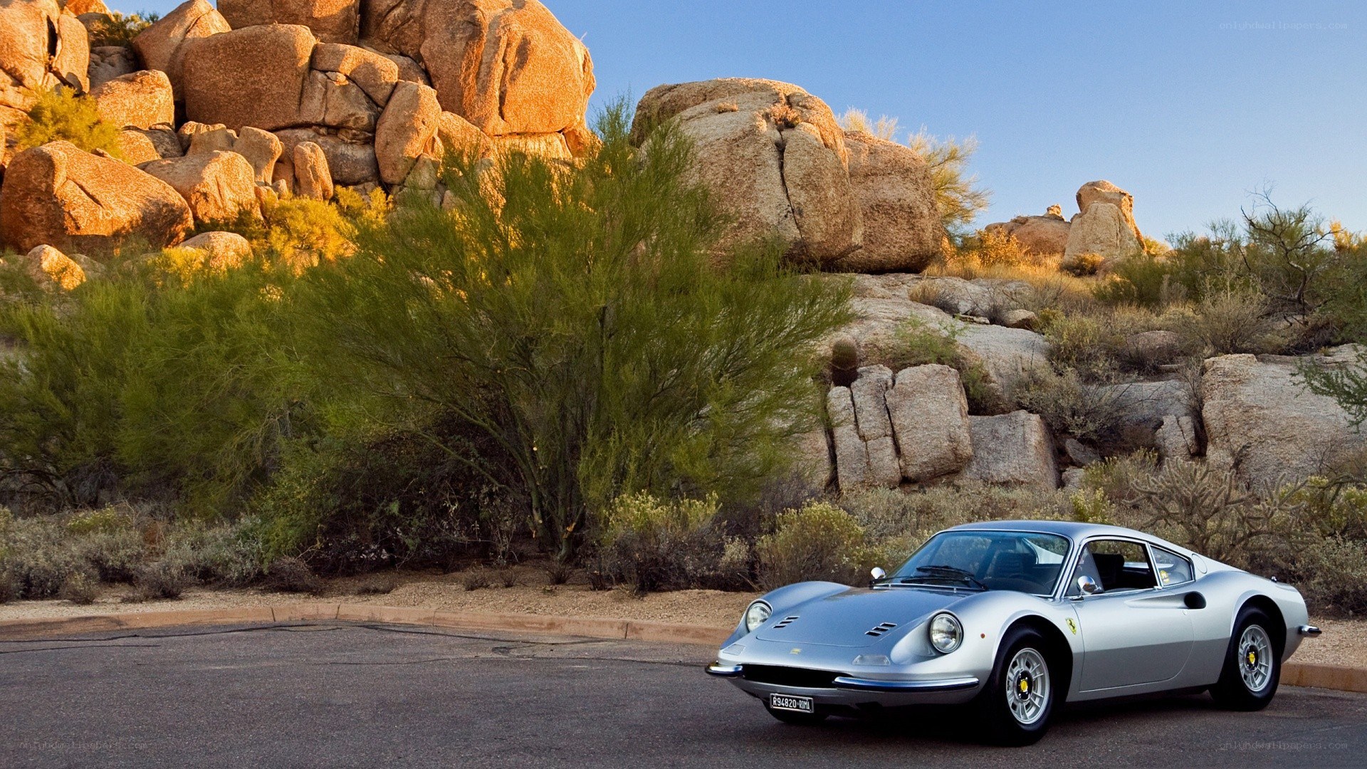 Silver Ferrari in desert landscape