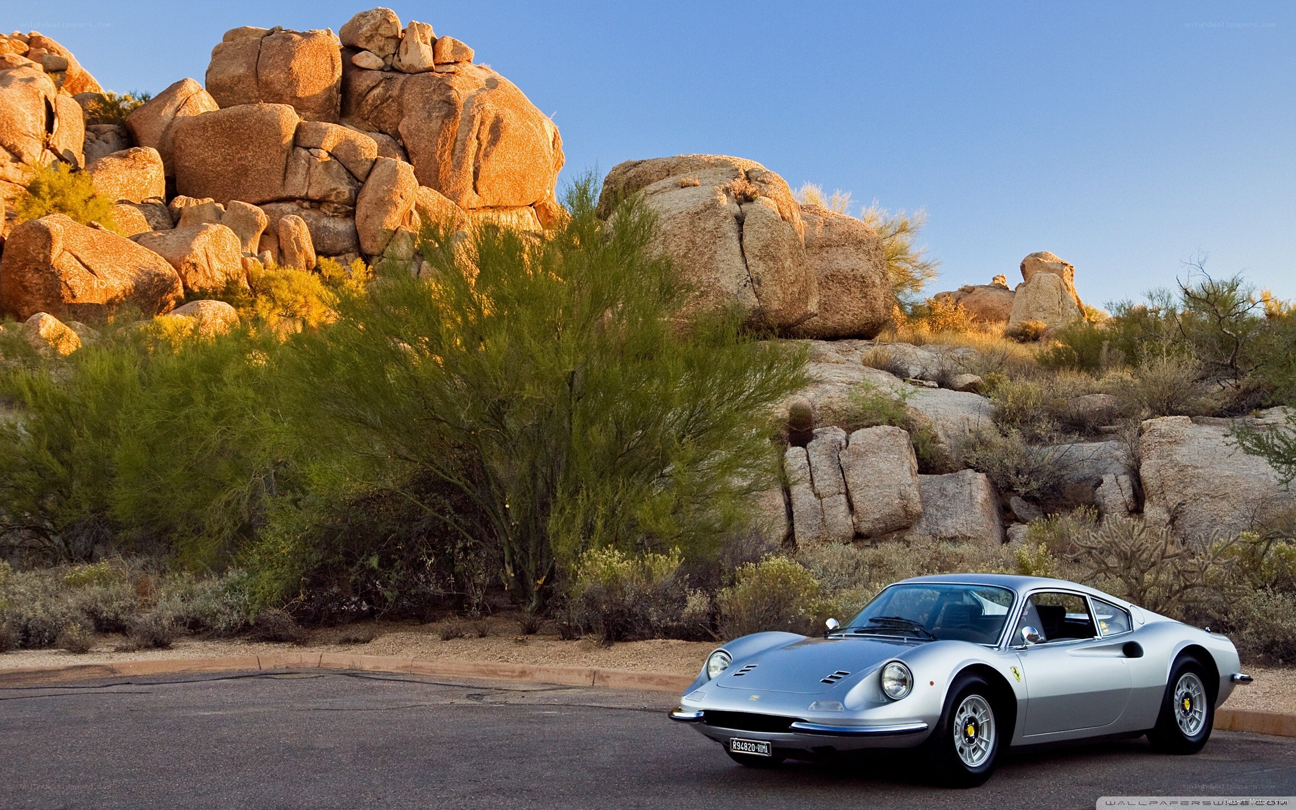 Silver Ferrari in desert landscape
