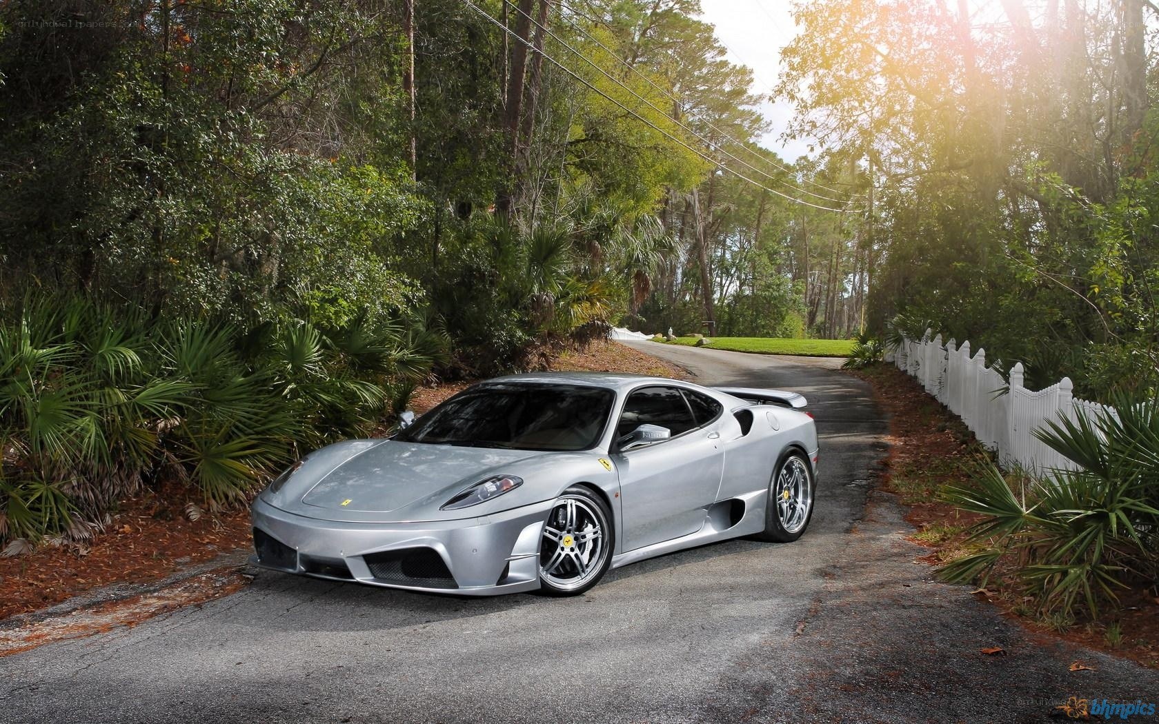 Silver Ferrari on a forest road