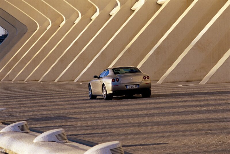 Silver Ferrari on a modern bridge