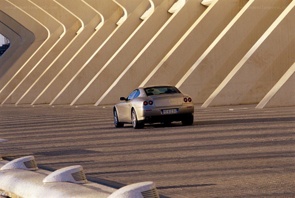 Silver Ferrari on a modern bridge