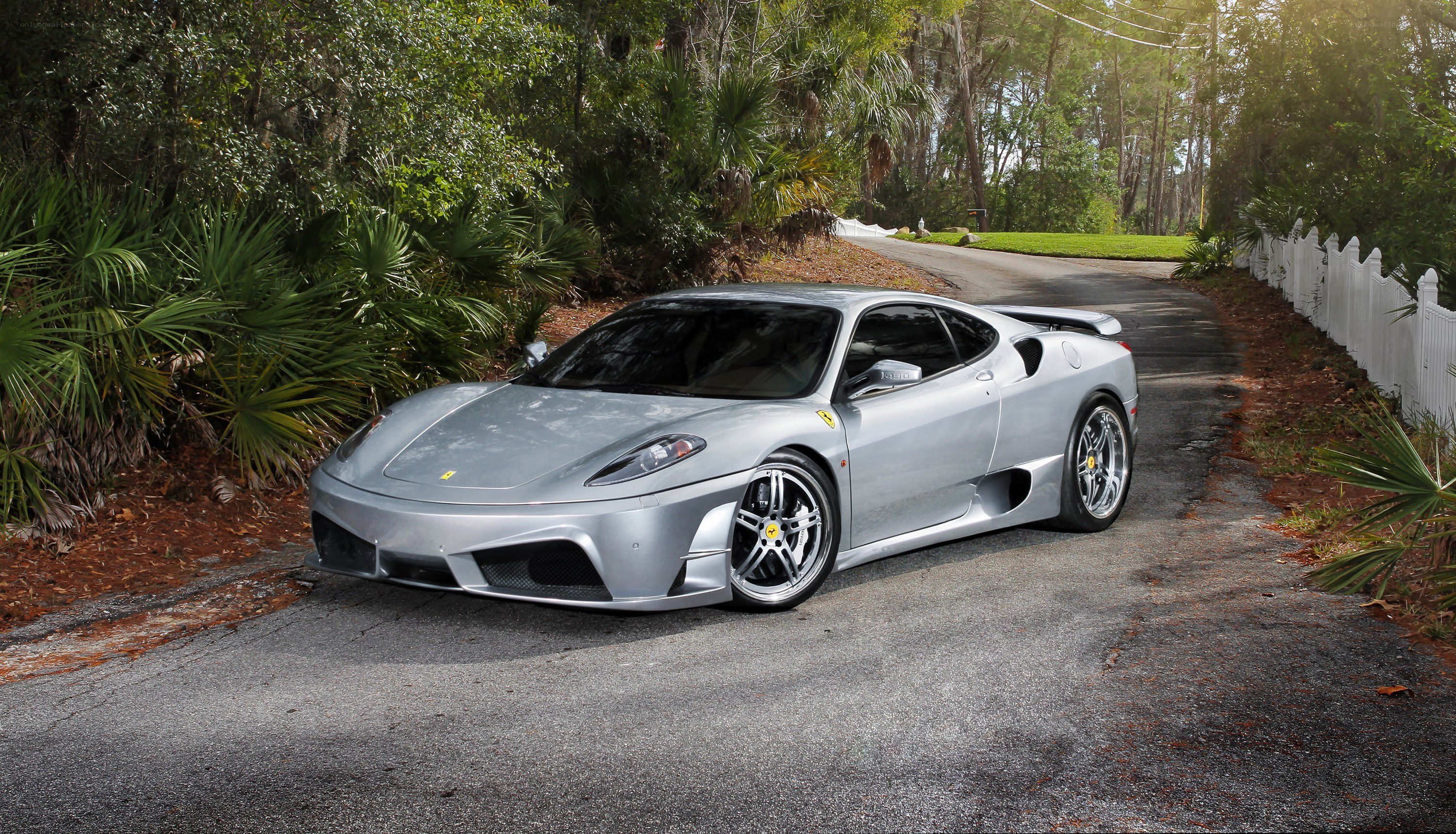 silver ferrari on a quiet road