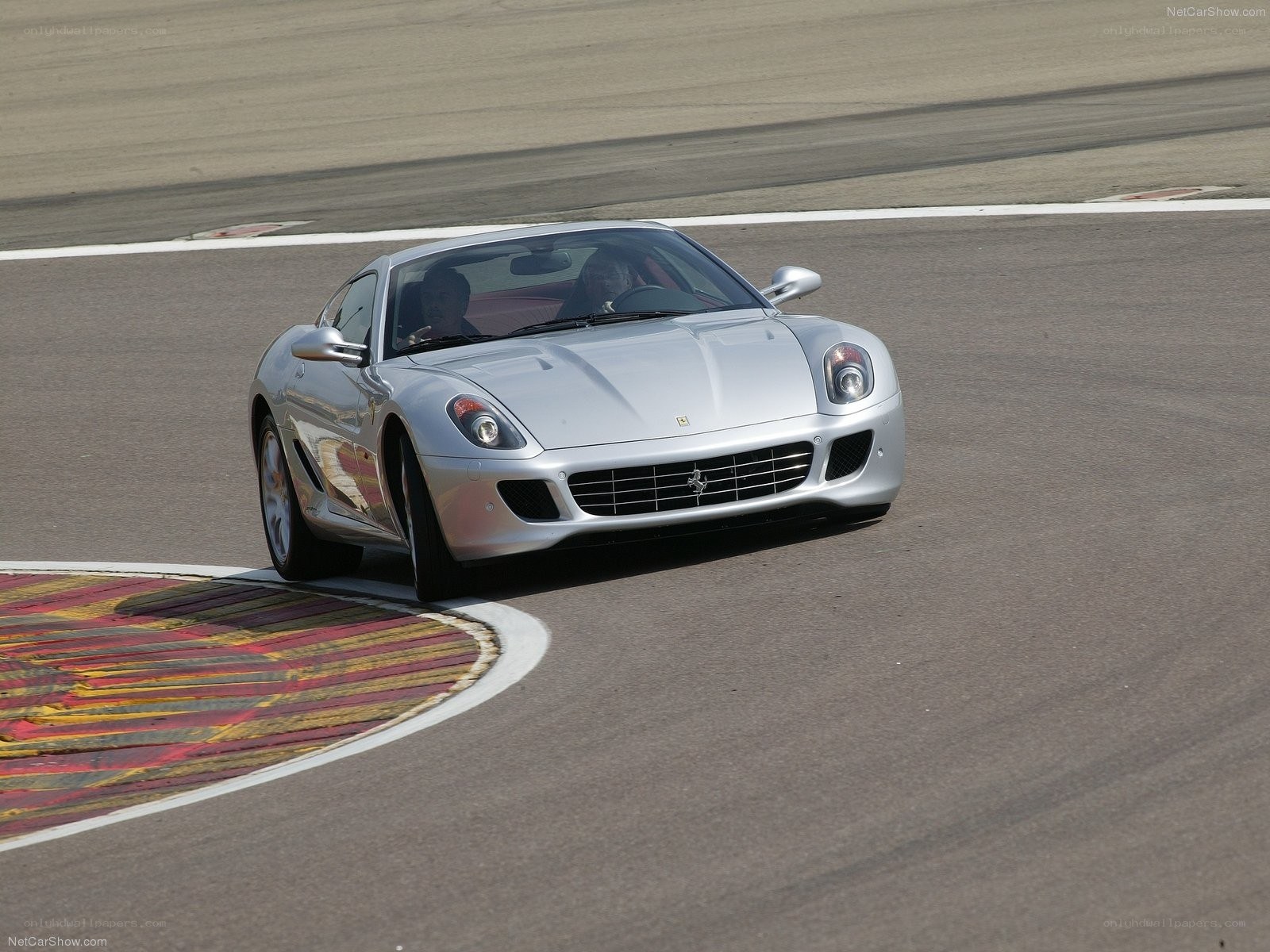 Silver Ferrari on a racetrack