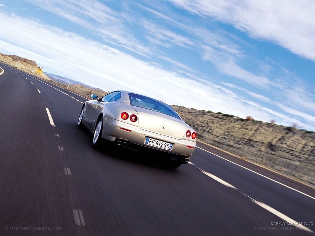 silver ferrari on a winding road