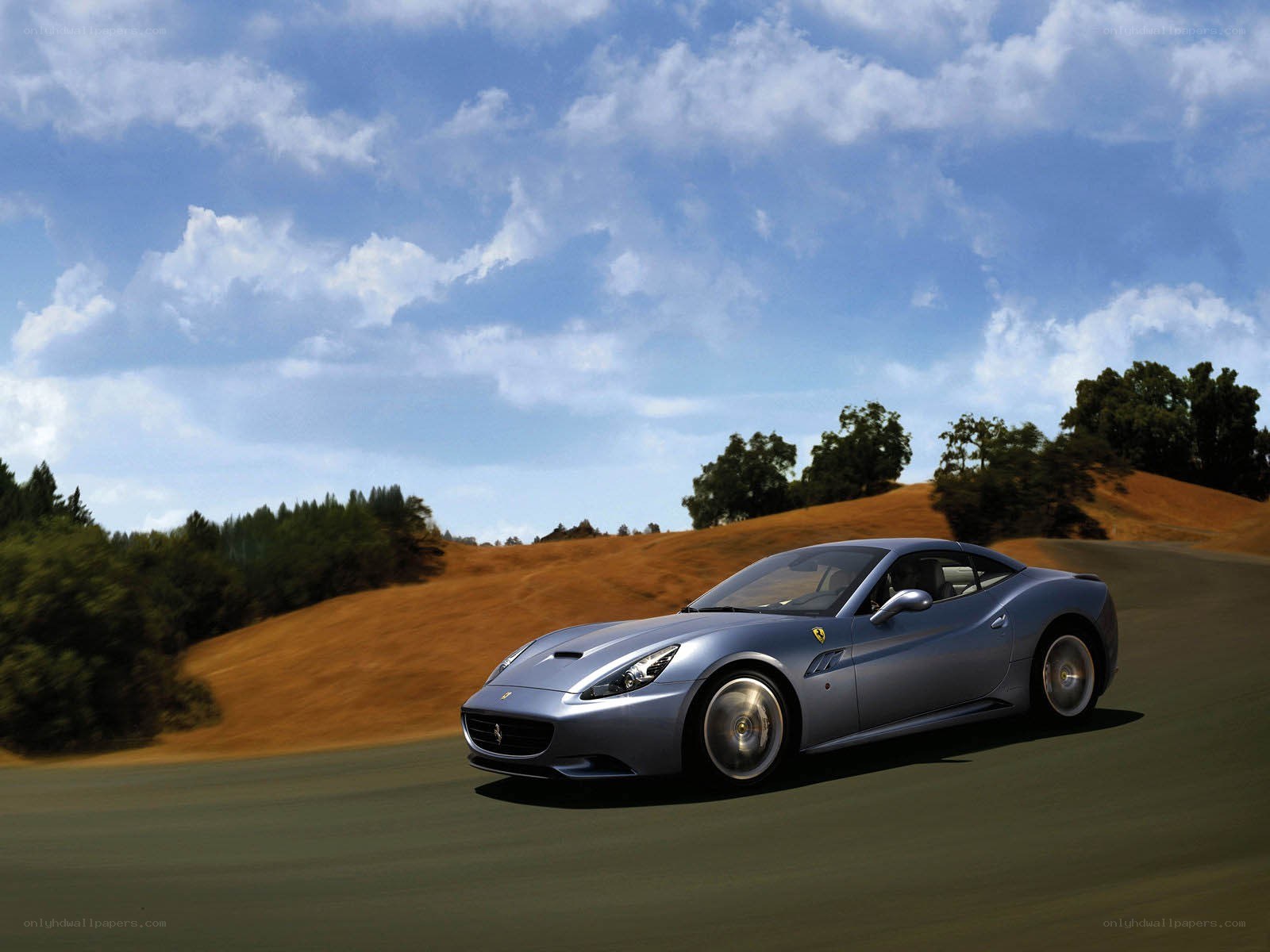 Silver Ferrari on a winding road