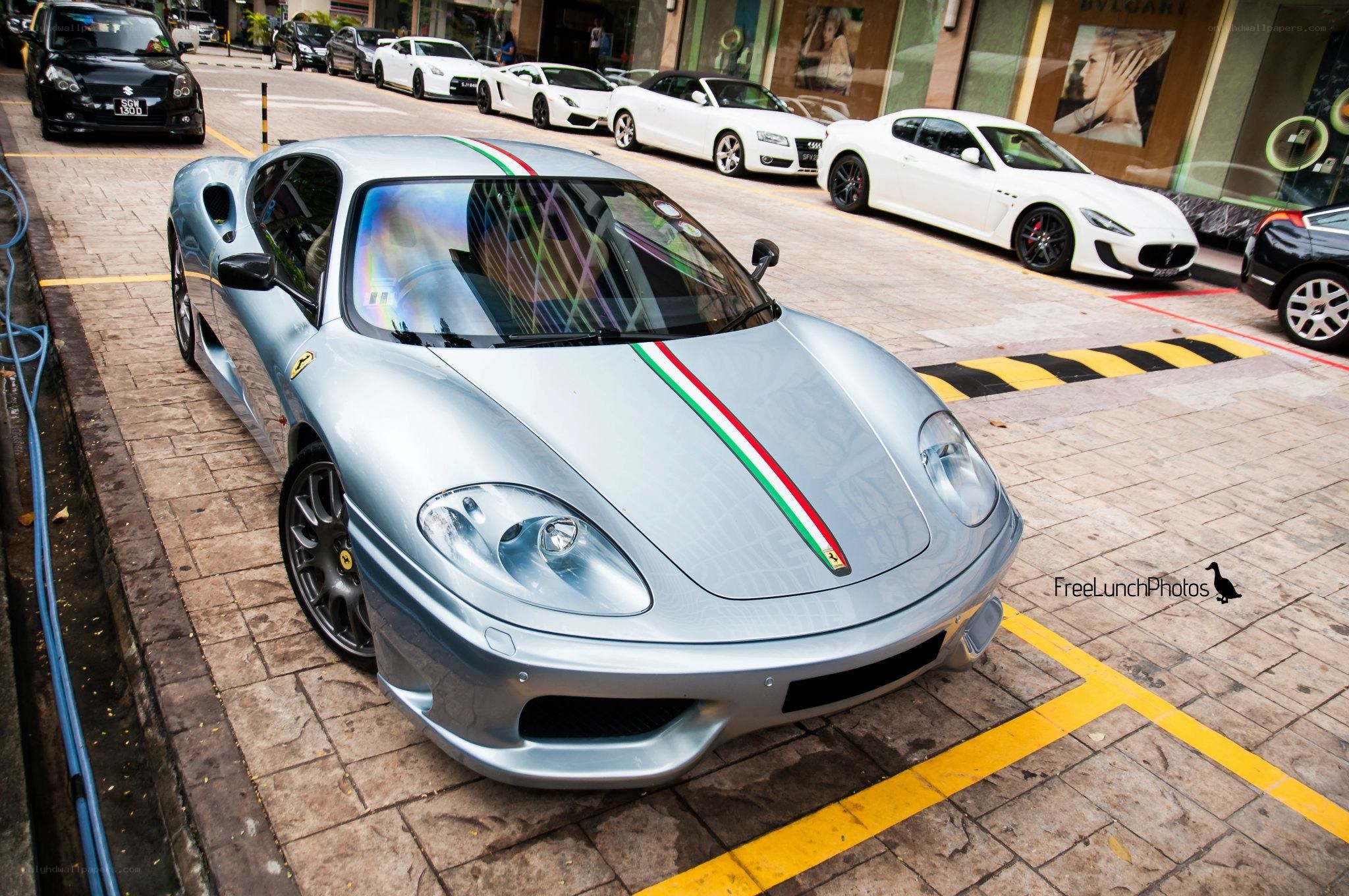 Silver Ferrari on city street