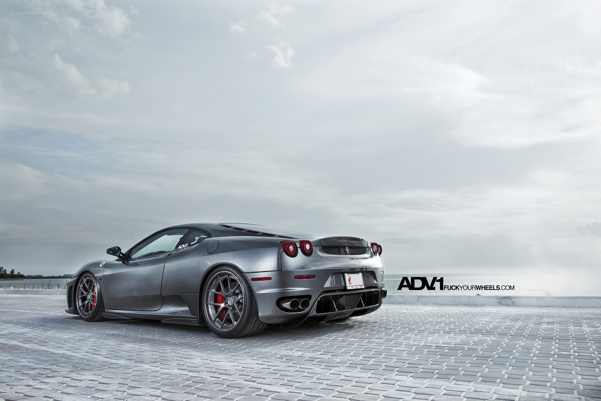 silver ferrari on cobblestones