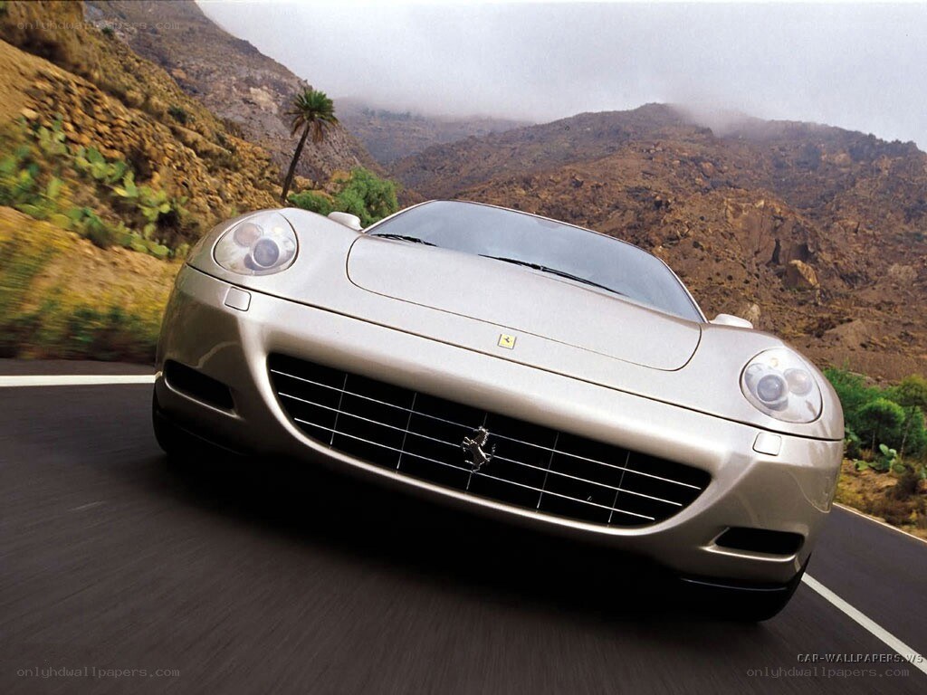 silver ferrari on mountain road