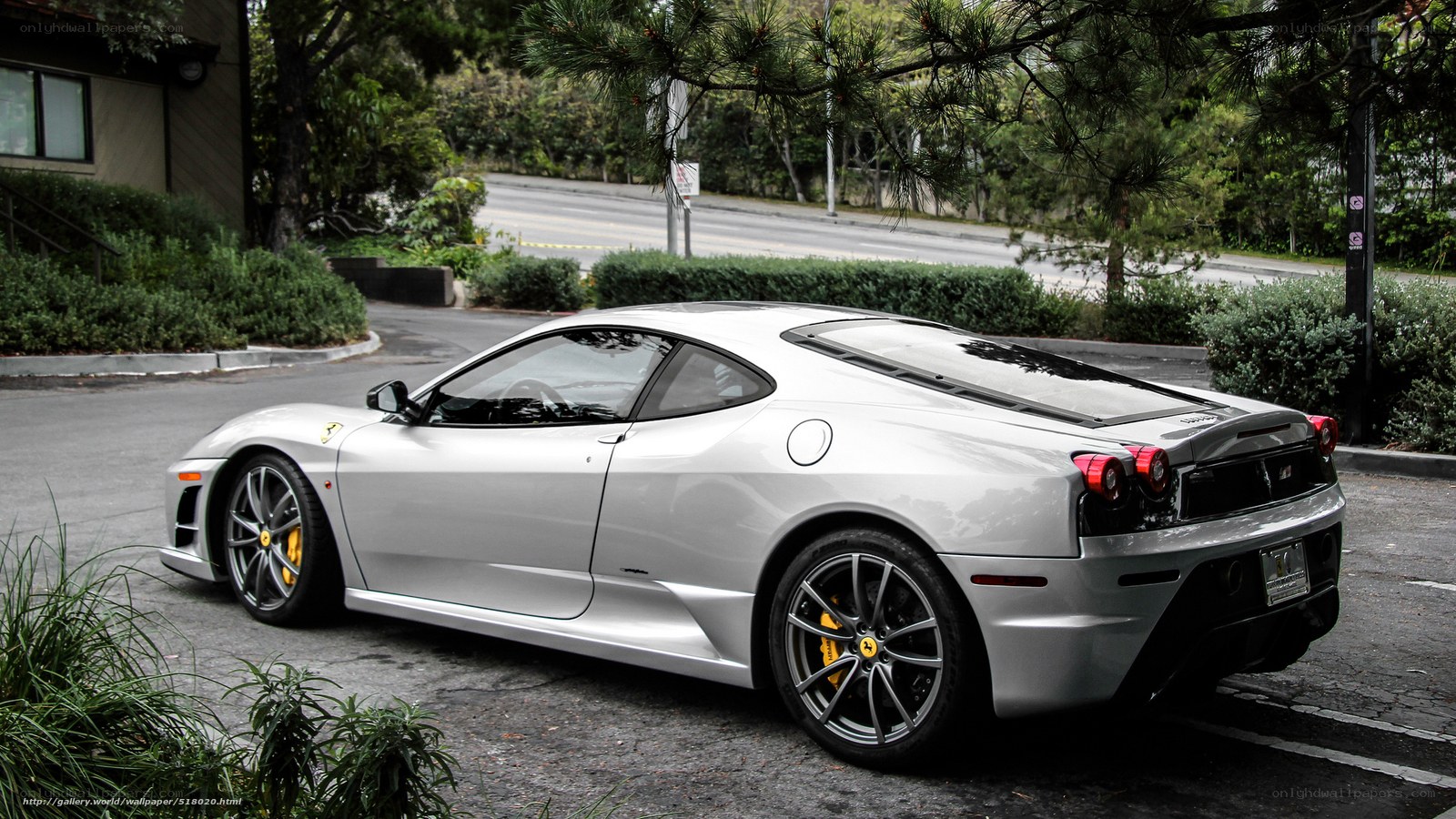 silver ferrari parked on street