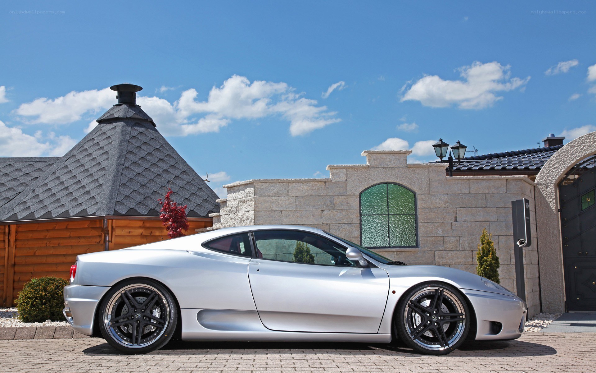 Silver Ferrari parked outside house