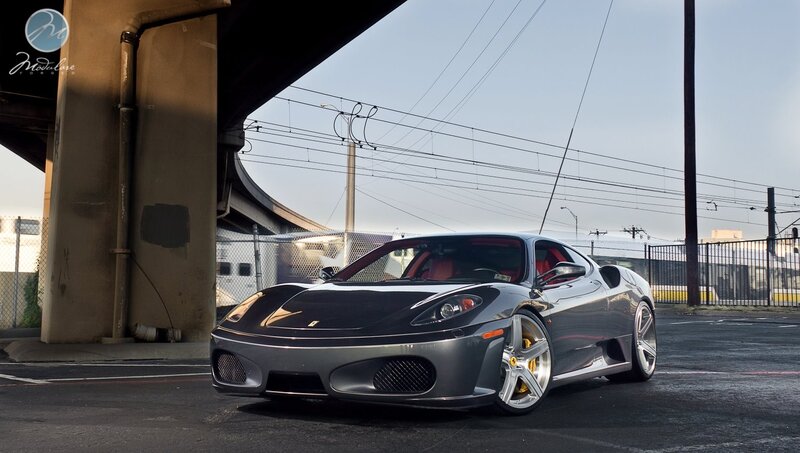 Silver Ferrari parked under overpass