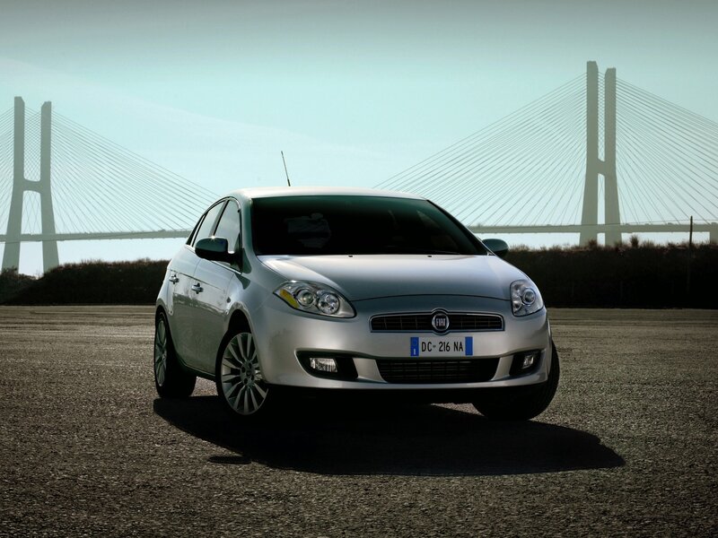 Silver Fiat Punto by a bridge
