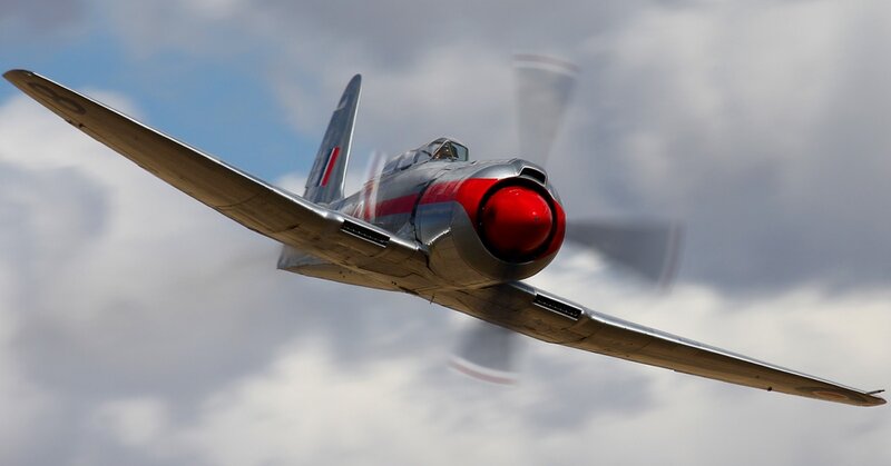 Silver fighter plane in flight