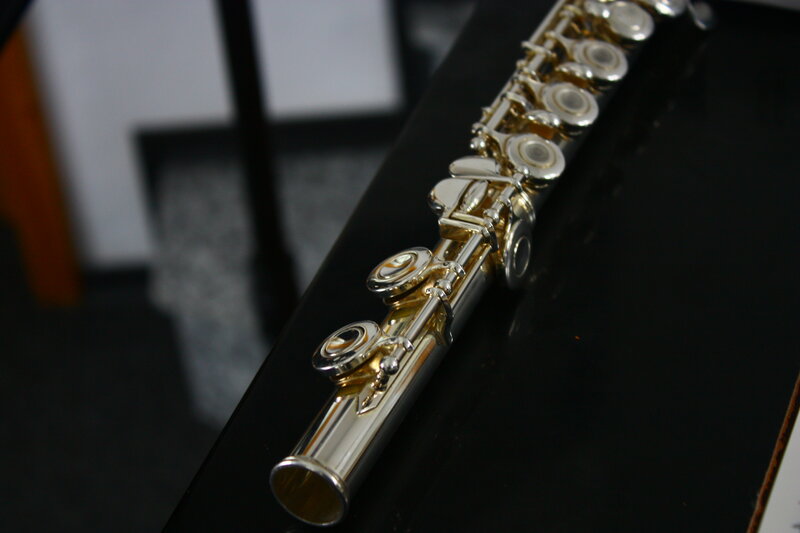 Silver Flute on Black Surface