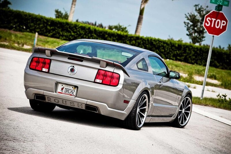 silver ford mustang at stop sign