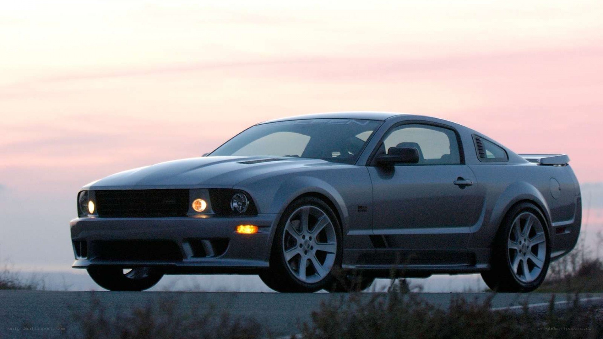 silver ford mustang at sunset