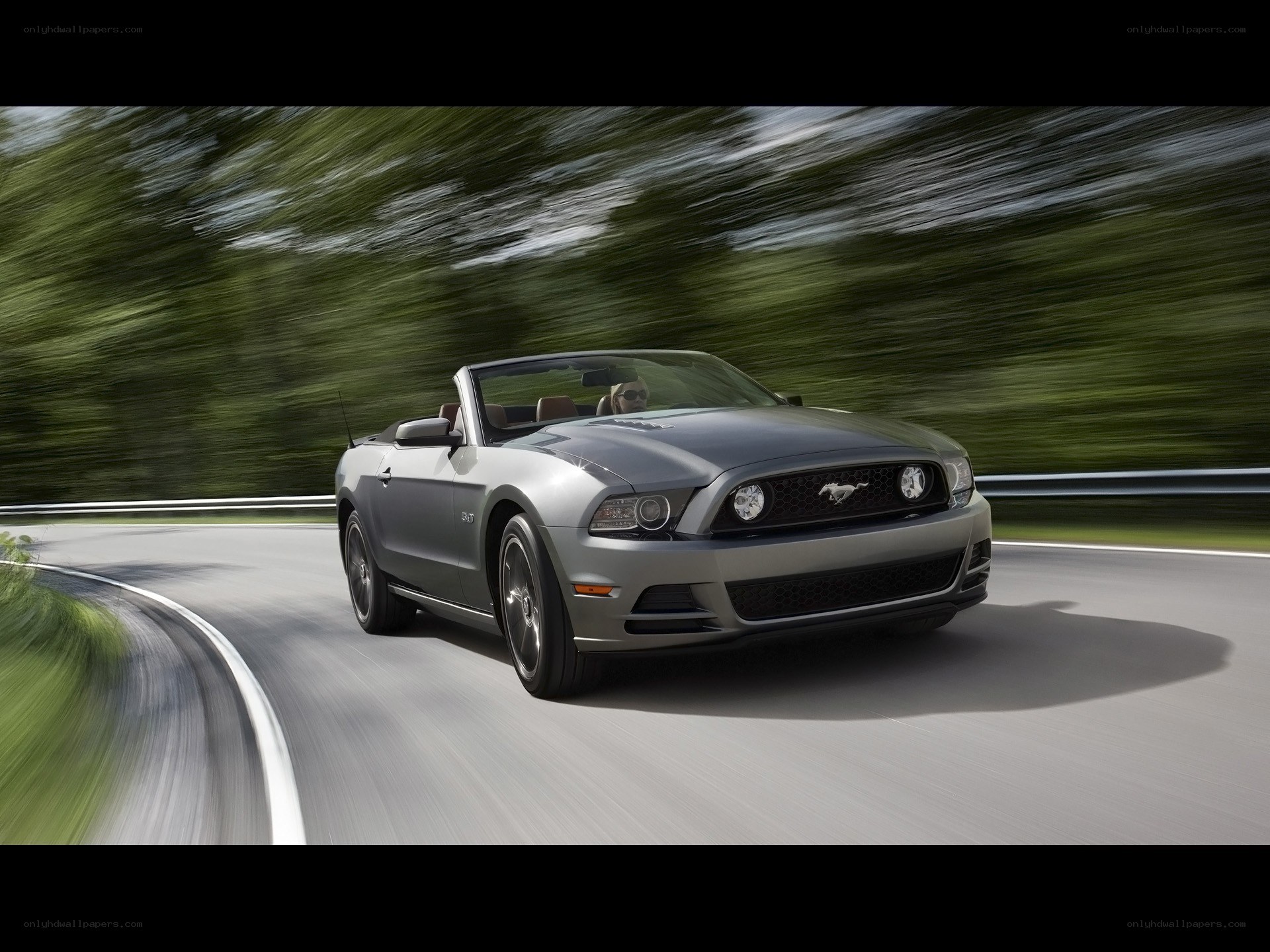 Silver Ford Mustang convertible driving