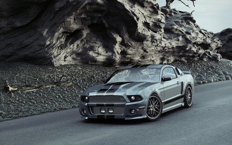 Silver Ford Mustang on a rocky road