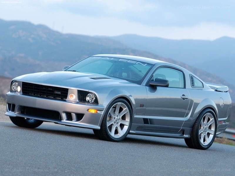 silver ford mustang on mountain road