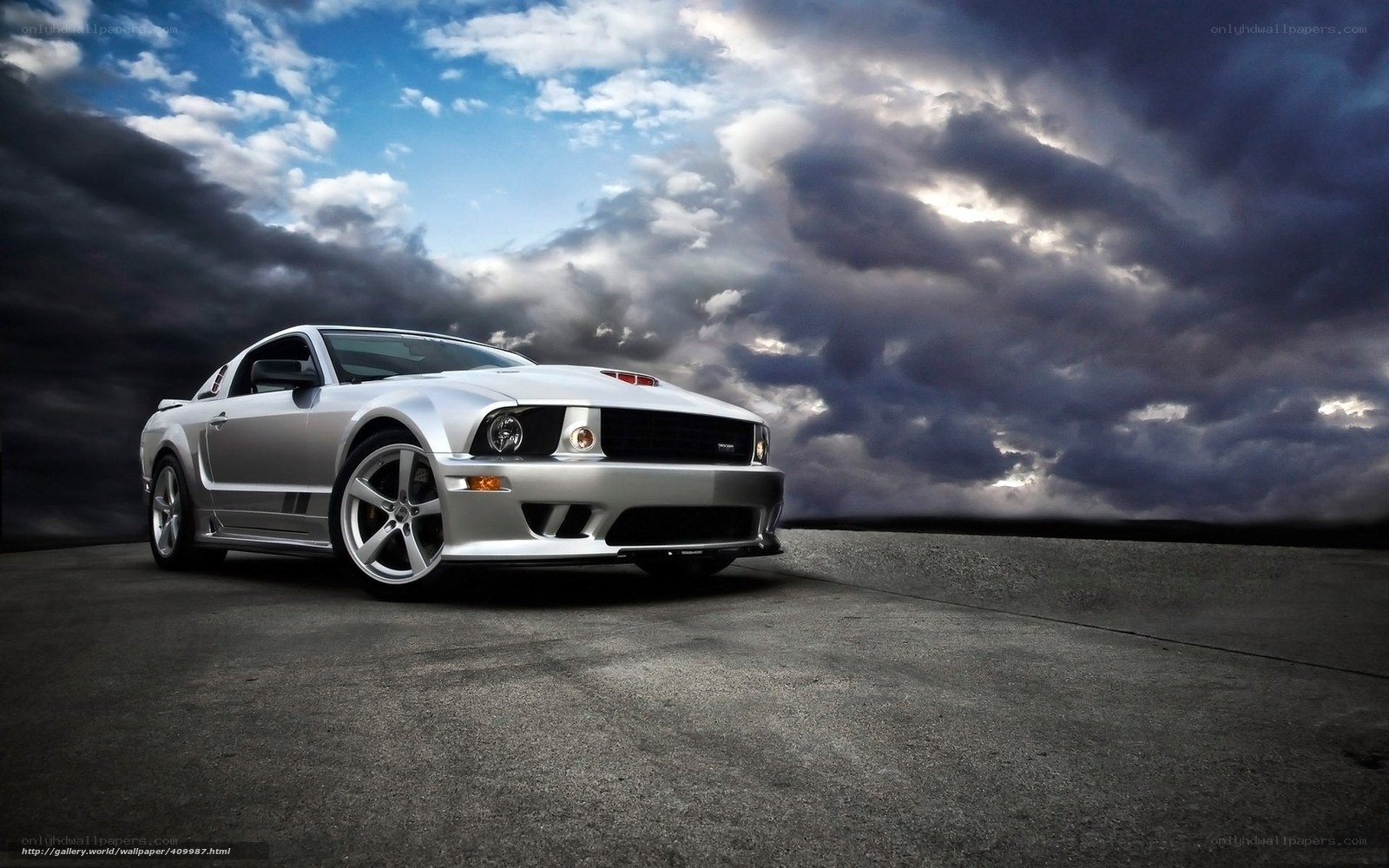 Silver Ford Mustang on stormy road
