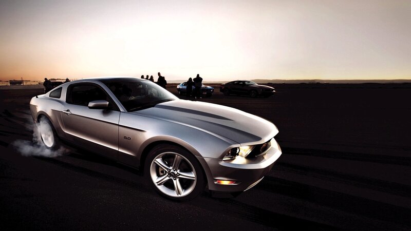 Silver Ford Mustang performing burnout