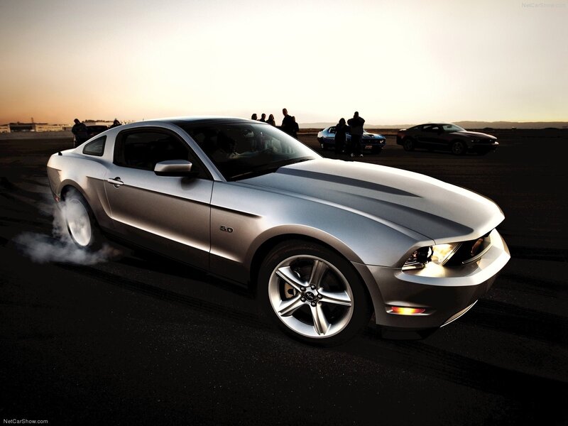 Silver Ford Mustang performing burnout