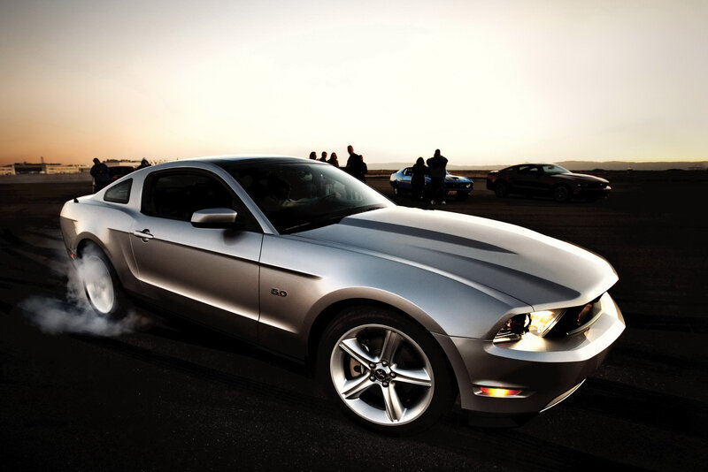 Silver Ford Mustang performing burnout