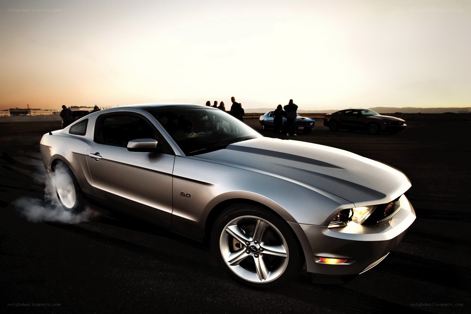 Silver Ford Mustang performing burnout