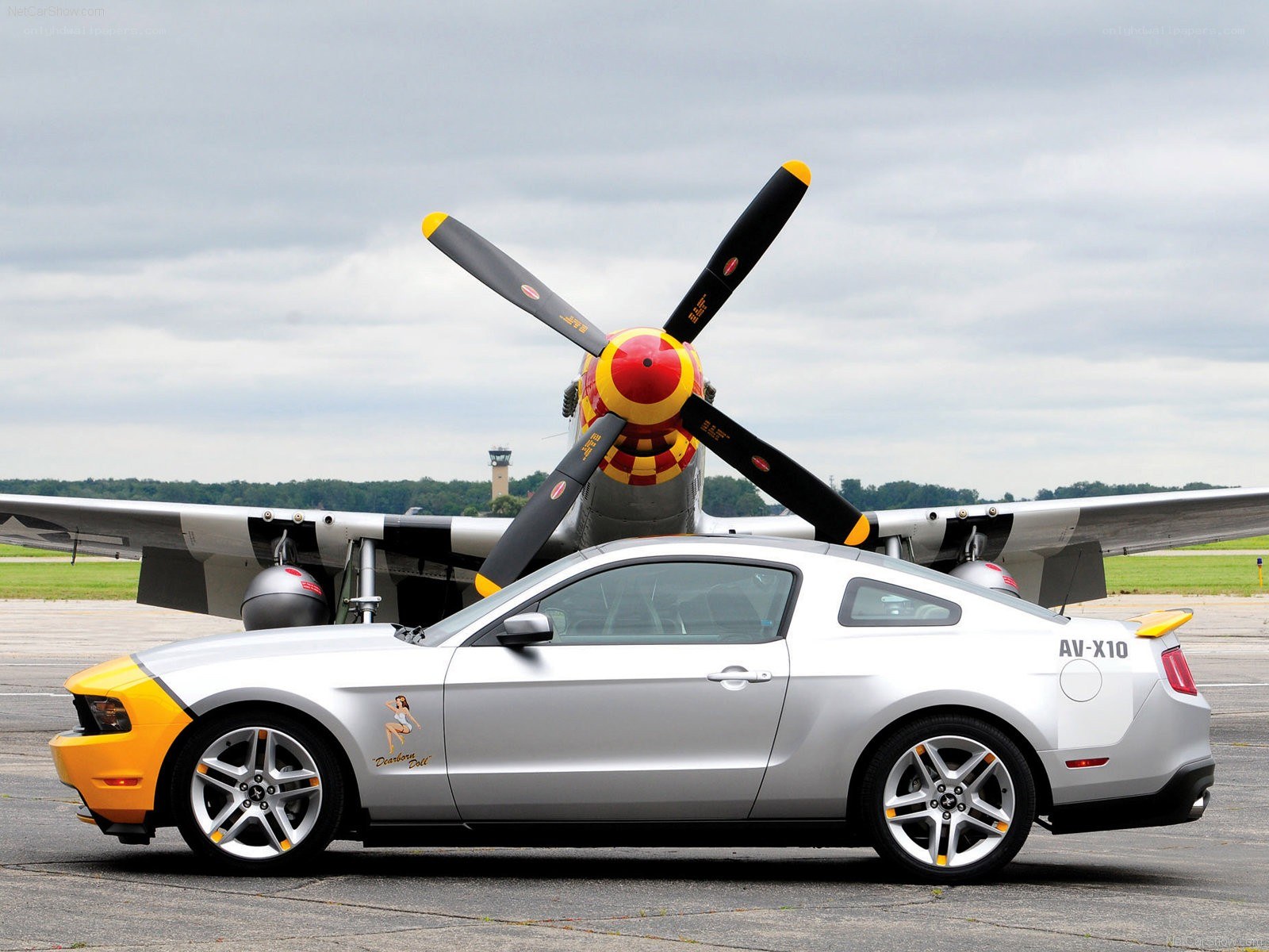 Silver Ford Mustang with airplane