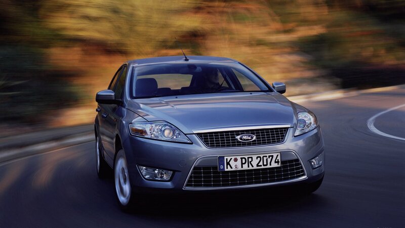 silver ford on winding road