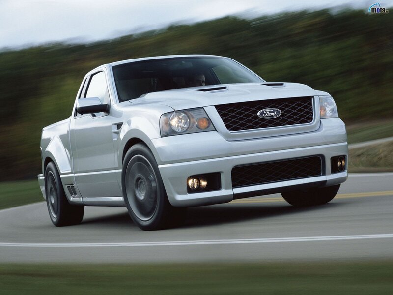 silver Ford pickup truck in motion