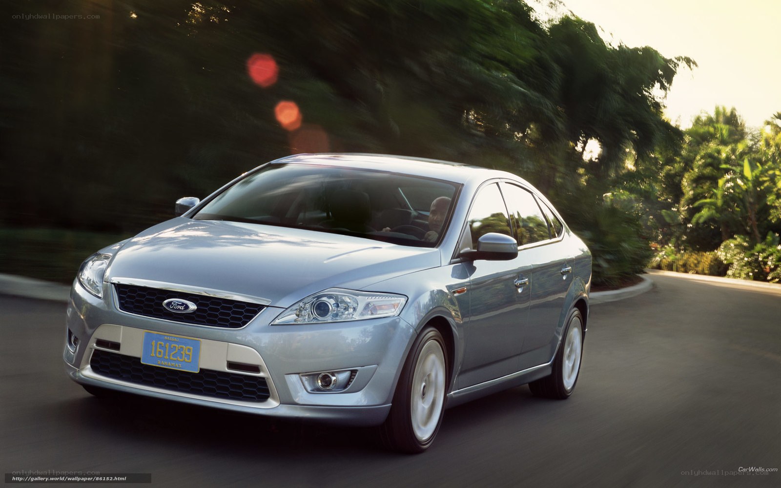 silver ford sedan on road