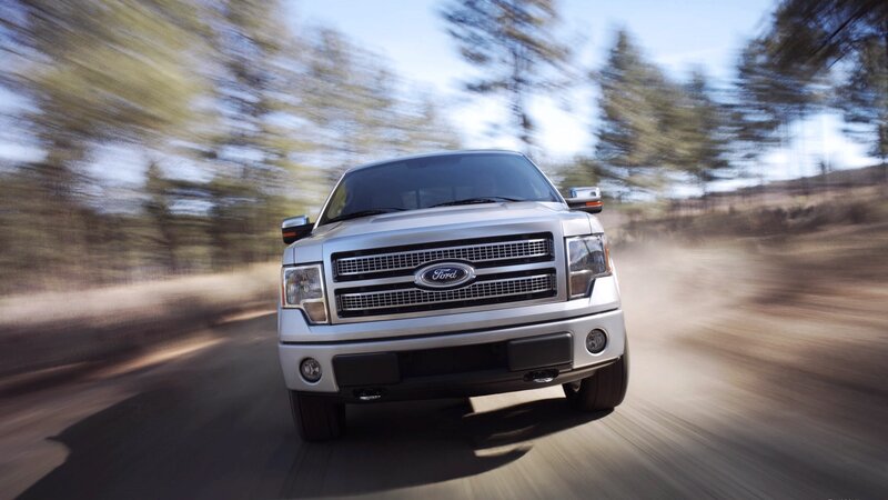 silver ford truck on dirt road