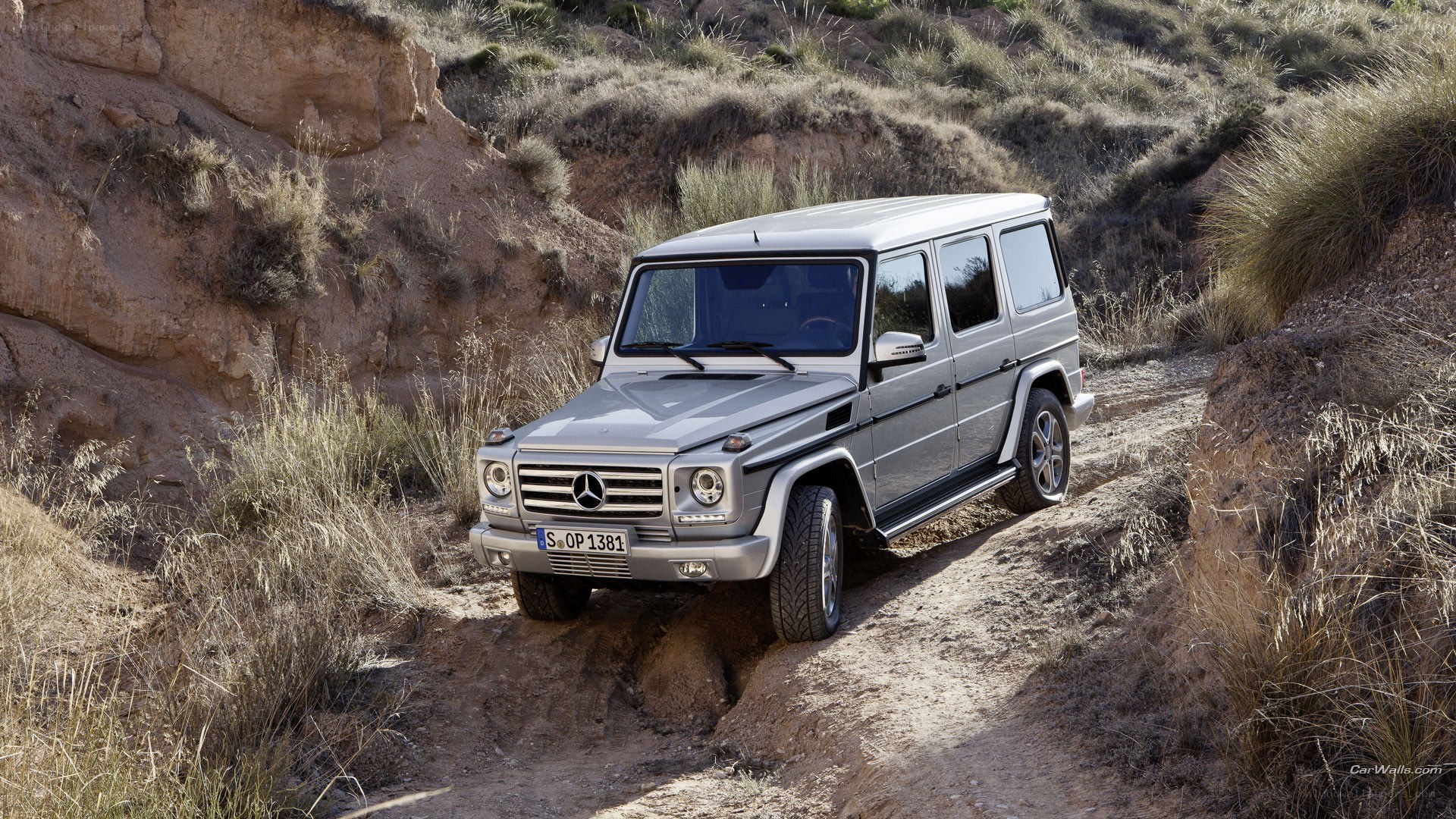 Silver G-Wagen on a dirt path