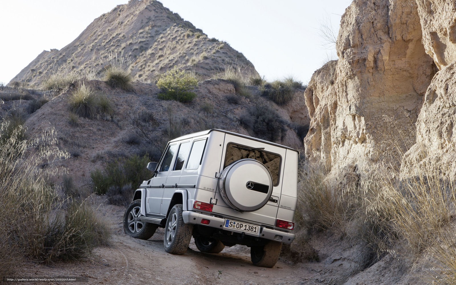 Silver G-Wagon in desert canyon