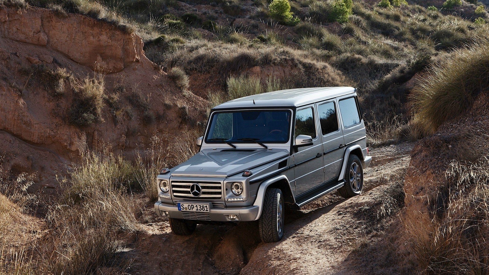 Silver G-Wagon on a dirt trail