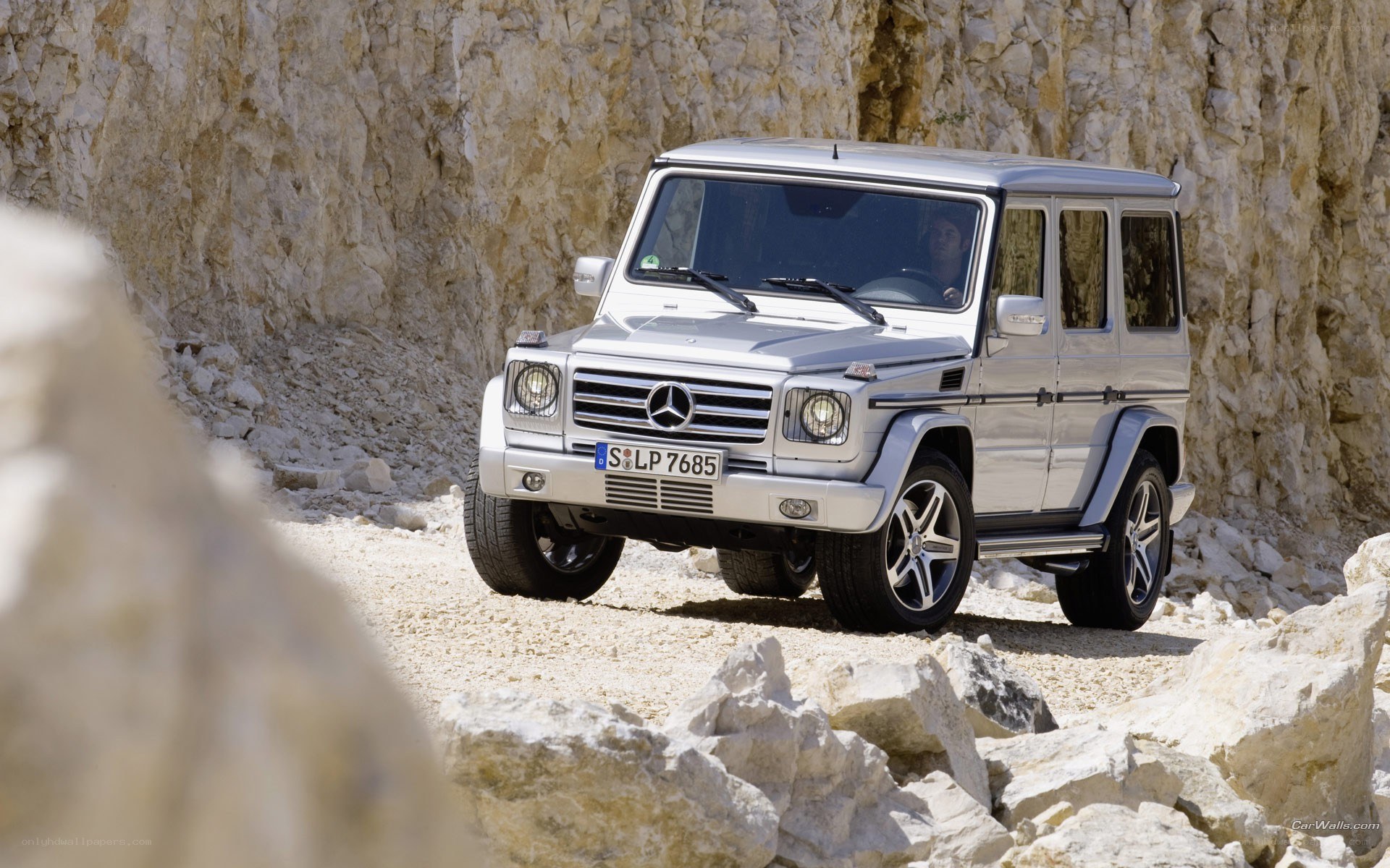 Silver G-Wagon on rocky terrain