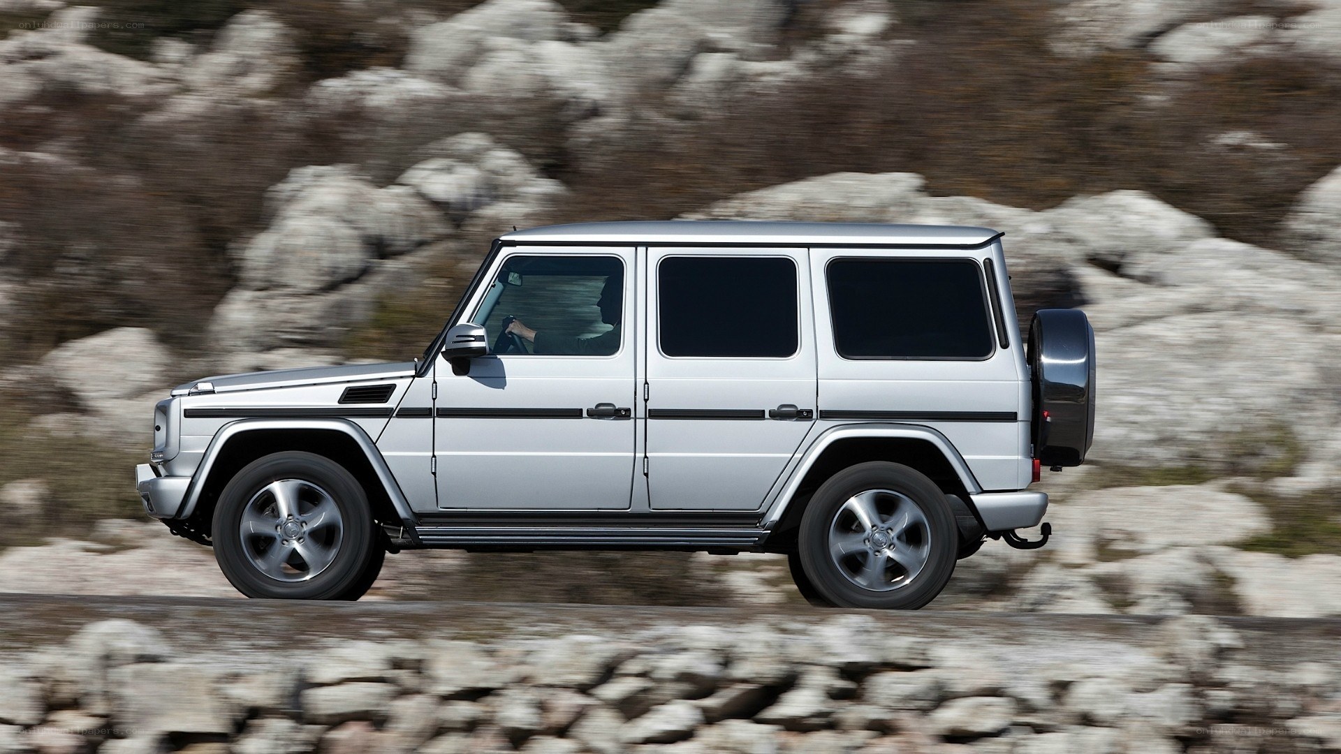 silver g-wagon on rocky terrain